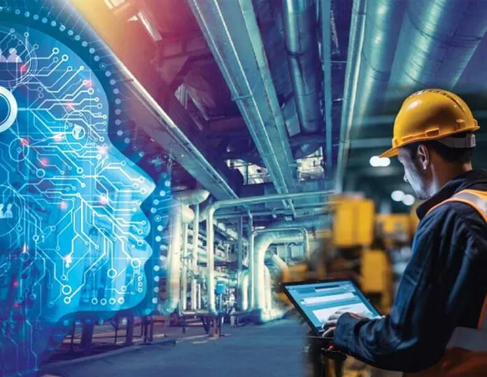 Engineer using a tablet beside industrial pipework
